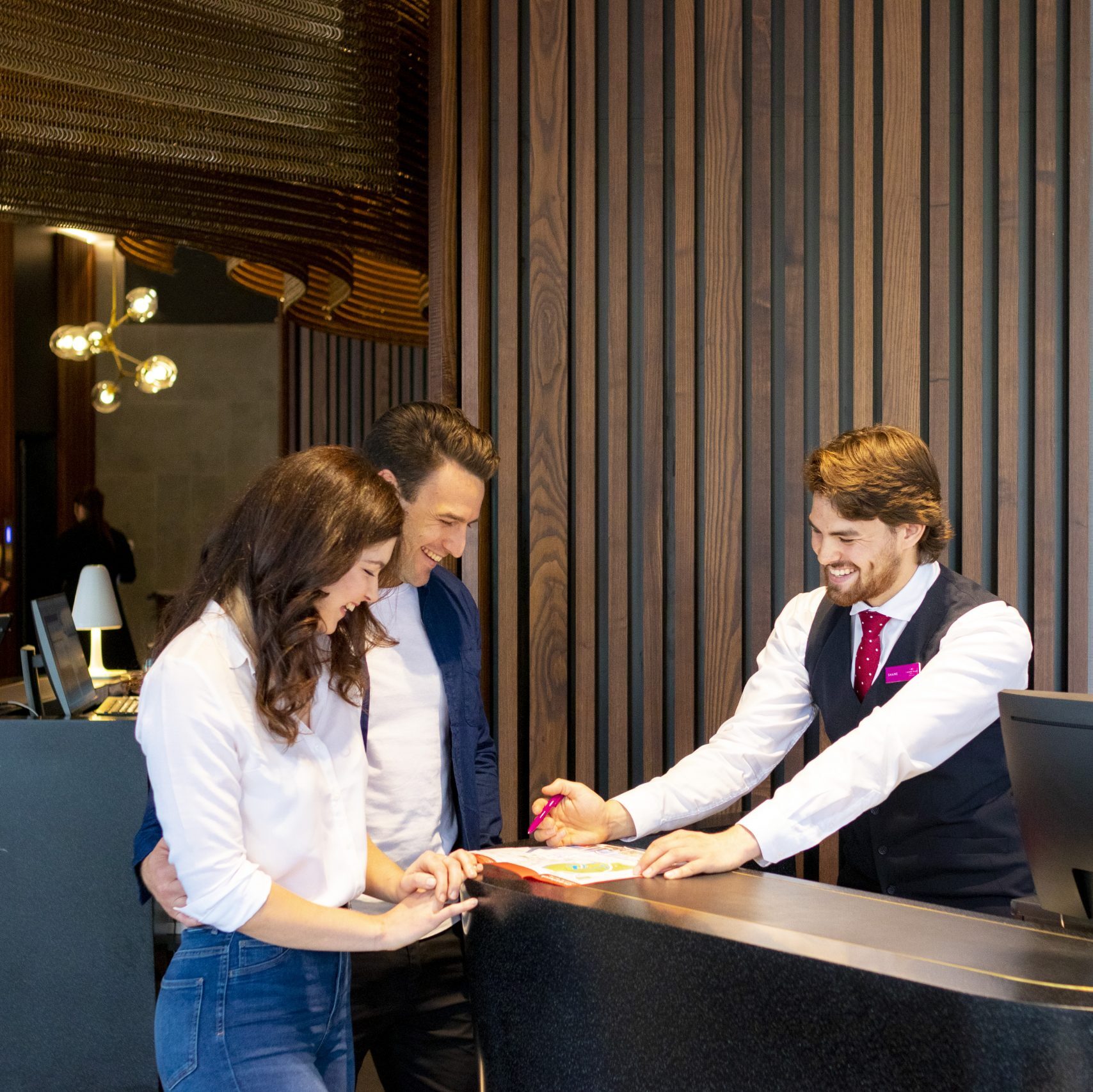 Friendly Concierge and couple at Crowne Plaza Christchurch Hotel Lobby & Reception
